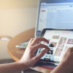 person holding black iPad simulating user behavior
